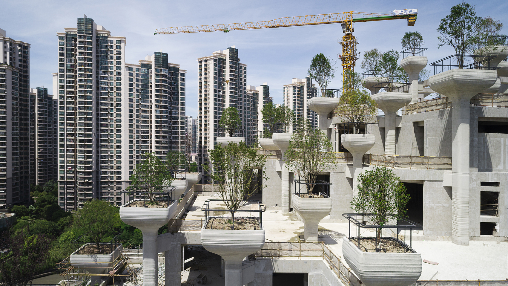 1000 Trees is a mixed-use complex in Shanghai that takes the form of two tree-covered mountains, populated by hundreds of columns