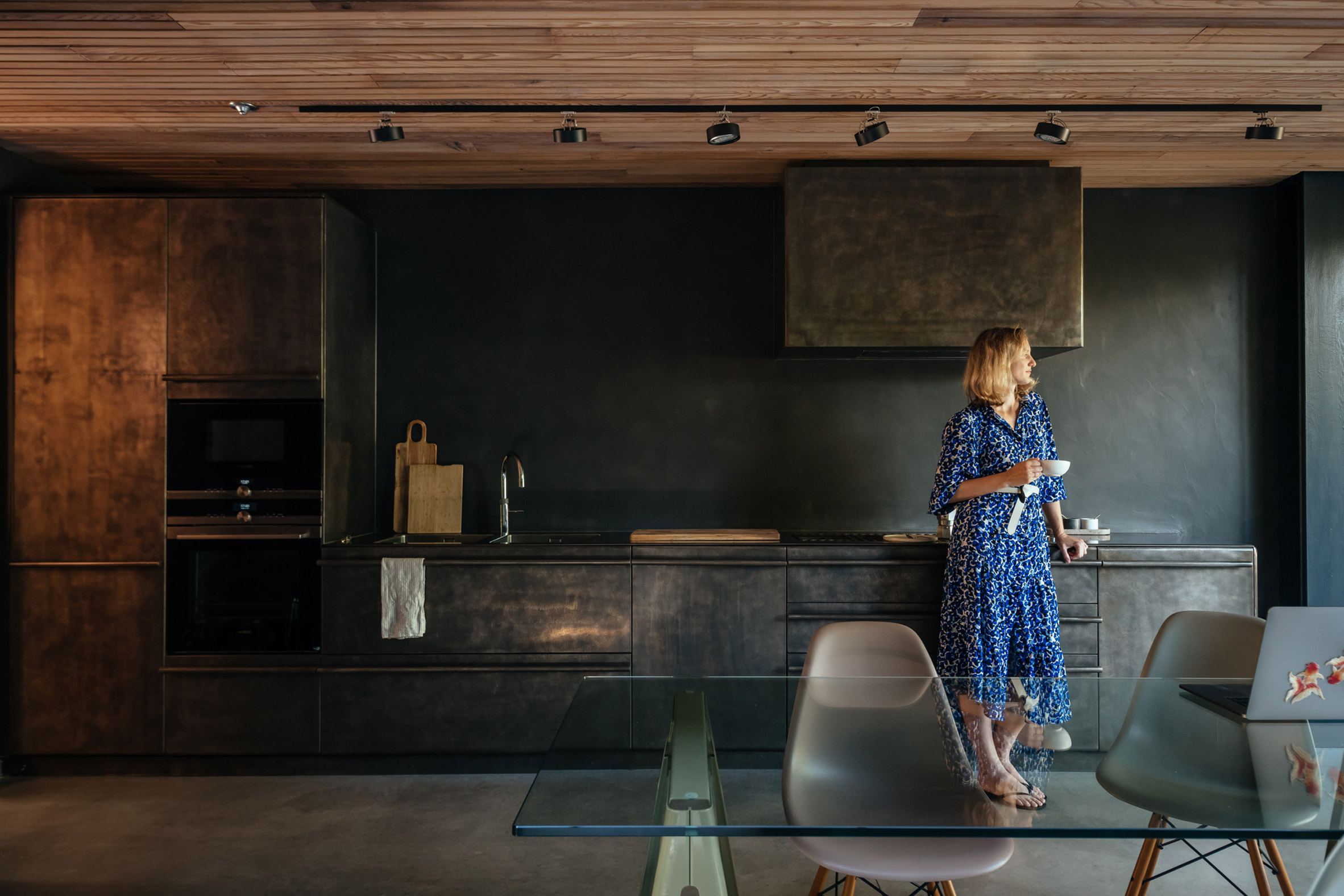 Woman in kitchen enjoying coffee
