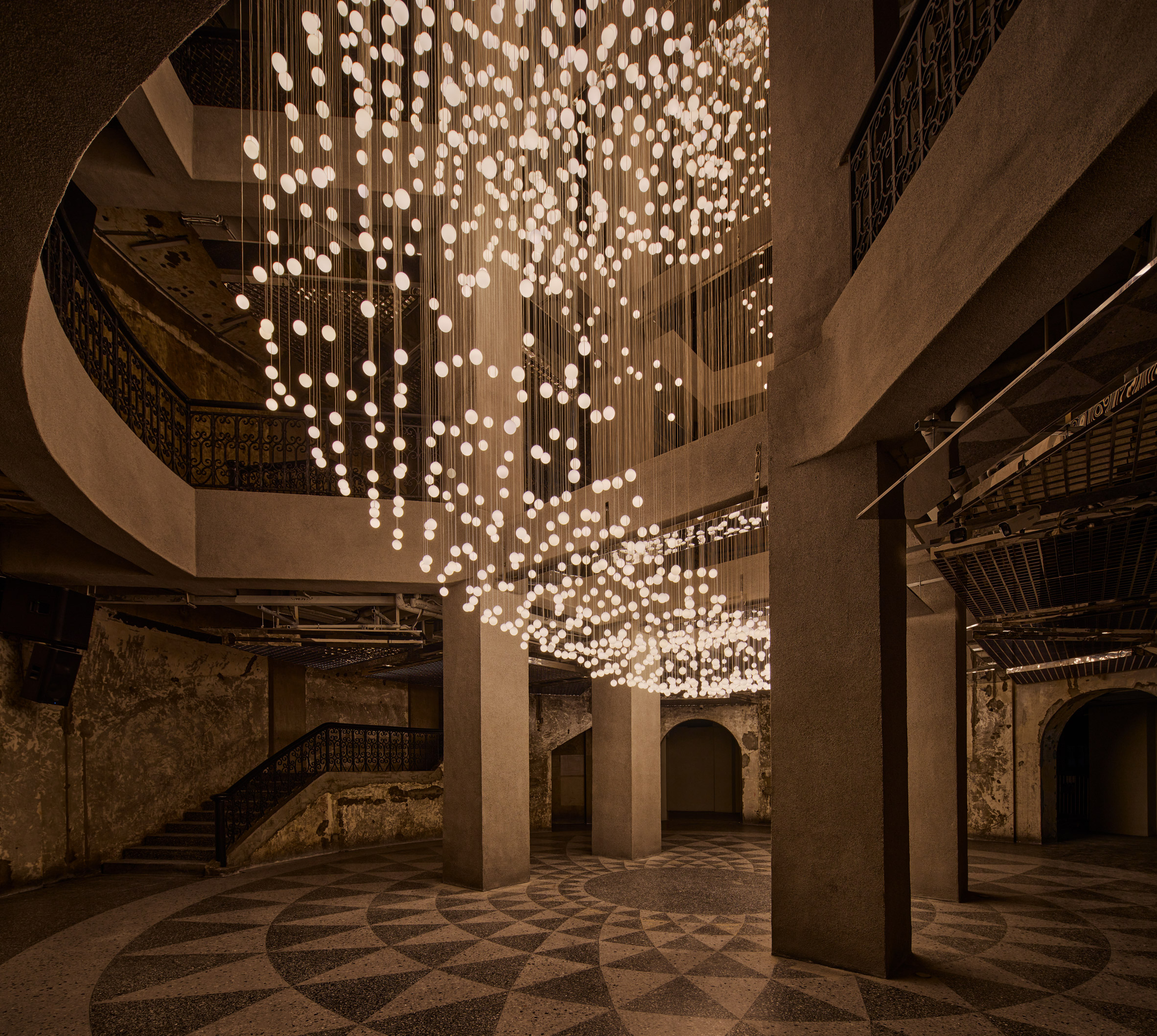 Light installation hanging from ceiling named Nebula
