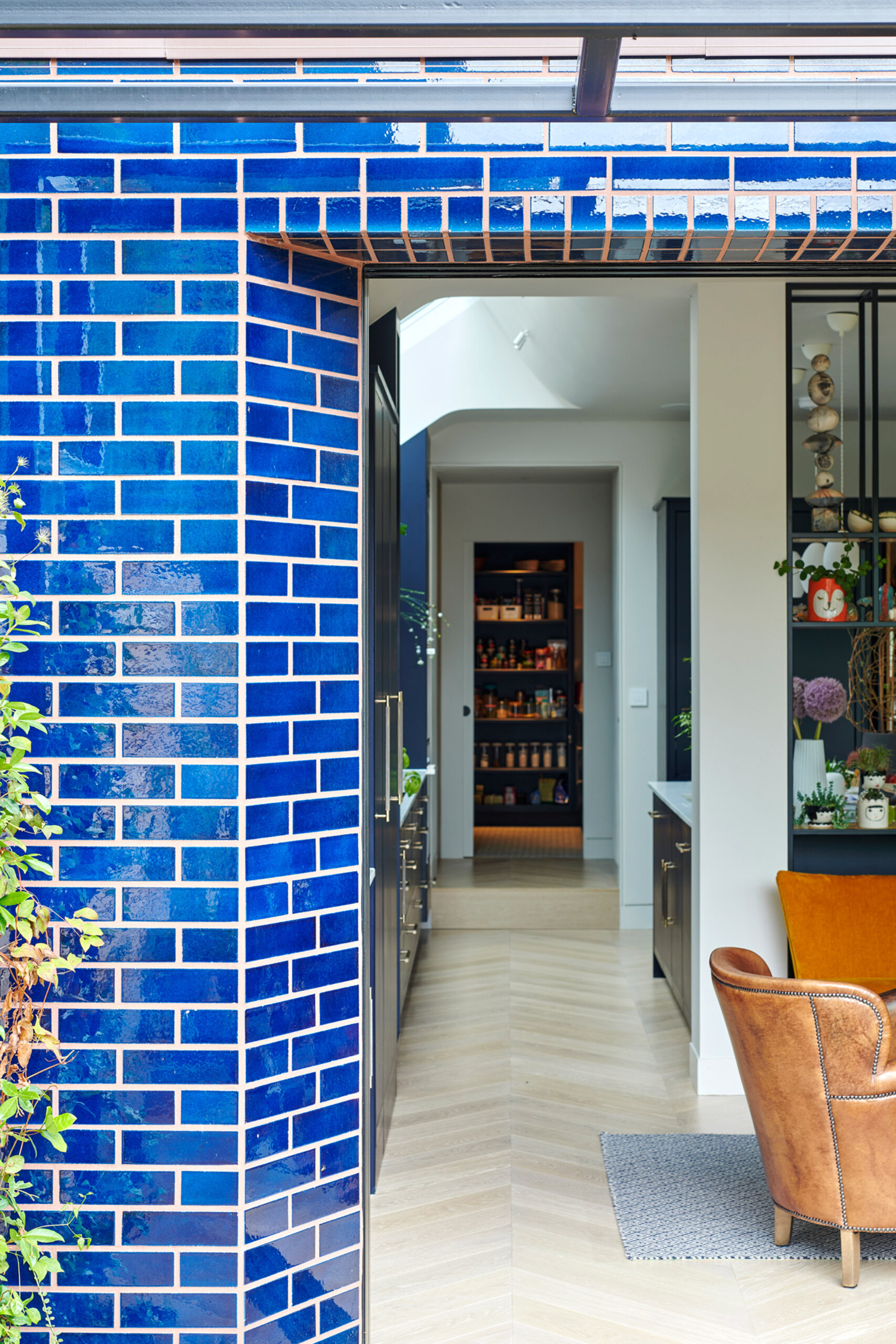 House extension clad in dark blue metro-style tiles